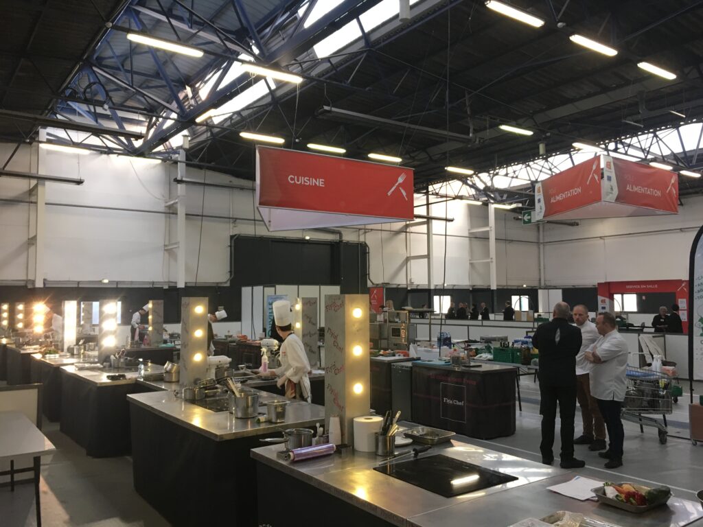 Vue d'ensemble du pôle cuisine des Olympiades des Métiers à Caen&nbsp;: postes Flyin'Chef alignés sous l'enseigne Cuisine