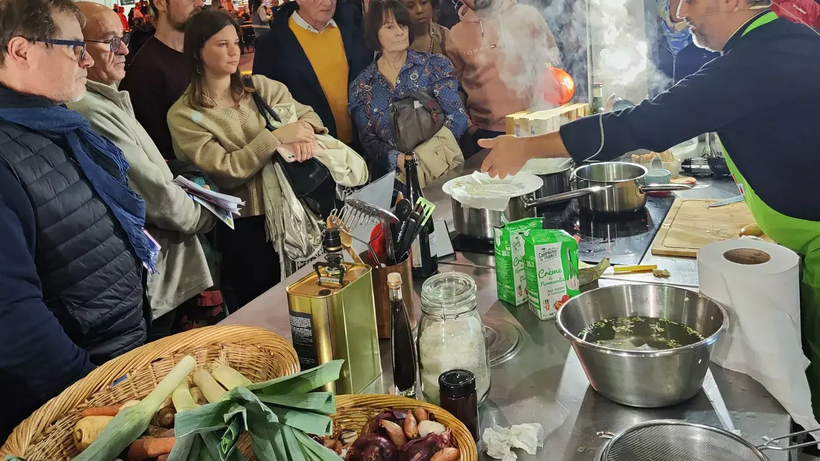 Comptoir de cuisine mobile Flyin'Chef installé au salon FENO, chef en démonstration devant le public dans un parc des expositions